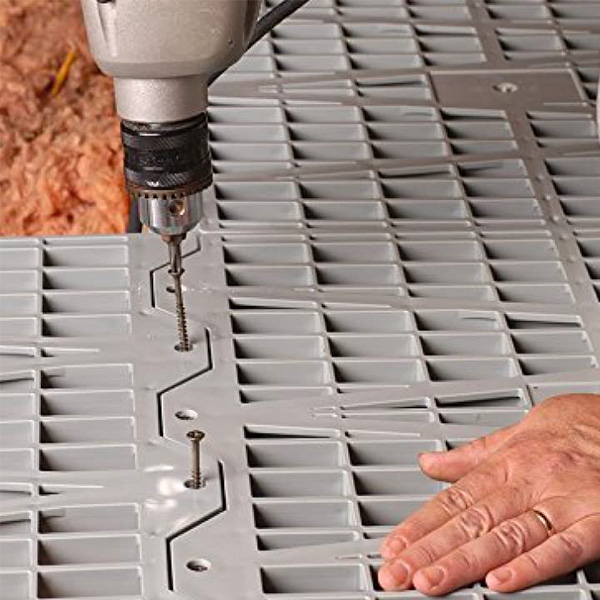 Attik Dek attic flooring installed over ceiling joists in an attic